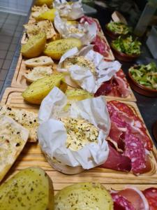 a table with many different types of pizzas on cutting boards at Hotel Restaurant Le Costabonne in Prats-de-Mollo-la-Preste