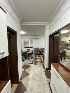 a kitchen and dining room with a table and chairs at Sara's House in Skopje
