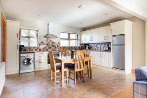 a kitchen with a table and chairs in a kitchen at Donegal Boardwalk Resort in Carrigart