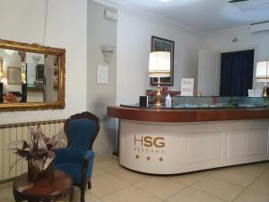 a dressing room with a hsbc sign and a mirror at Hotel San Giorgio in Bergamo