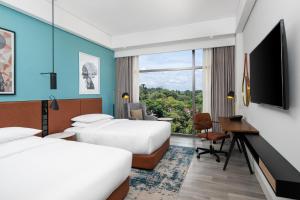 A bed or beds in a room at Four Points by Sheraton Kampala