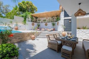 a patio with a table and chairs and a pool at Charming 3bed villa w/ pool, very close to centre in Kas