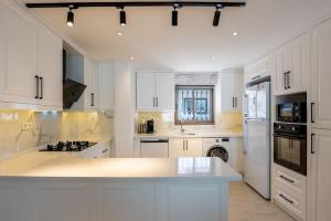a kitchen with white cabinets and a white counter top at Charming 3bed villa w/ pool, very close to centre in Kas
