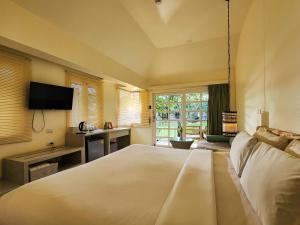 a large bedroom with a large bed and a television at Bandara On Sea, Rayong in Klaeng +75 photos
