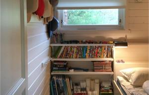 a bedroom with a book shelf filled with dvds at 4 Bedroom Cozy Home In Stavang in Stavang