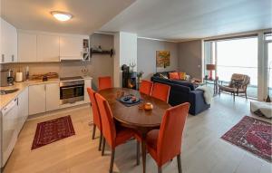 a kitchen and living room with a table and chairs at Cozy Apartment In Sjusjen With Kitchen in Sjusjøen