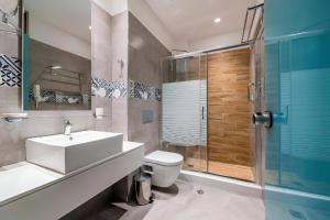 a bathroom with a toilet and a sink and a shower at Island Boutique Hotel in Rhodes Town +37 photos