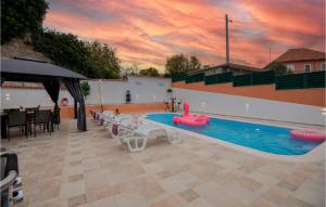 a pool with a pink swan in the middle of it at Awesome Home In Mijaca With Kitchen 