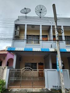 uma casa branca com uma varanda e duas janelas em SaamSaao HomeStay Betong สามสาวโฮมสเตย์เบตง 4 Bedroom House for Rent em Betong