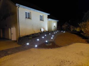 a group of lights in front of a house at night at La Sève de l'Olivier in Amblans-et-Velotte