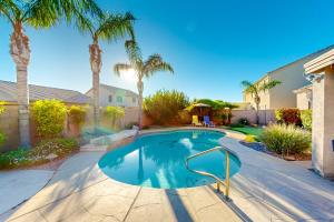 a swimming pool in a yard with palm trees at Desert Dream in Cave Creek