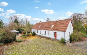 a white house with a red roof at Awesome Home In Haslev With Kitchen in Haslev