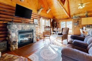 a living room with a fireplace in a log cabin at Hager Cabin 