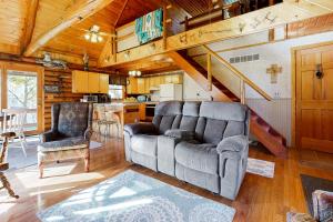 a living room with a couch and a kitchen at Hager Cabin 