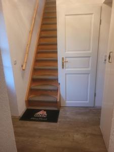a staircase with a door and a box on the floor at Ferienwohnung am neuen Teich in Lübz