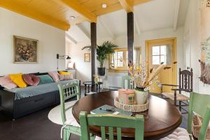 a living room with a couch and a table at Boutique Hotel Jongwijs Westzaan in Westzaan
