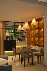 a dining room with a table and chairs and lights at Amérian Tucuman in San Miguel de Tucumán
