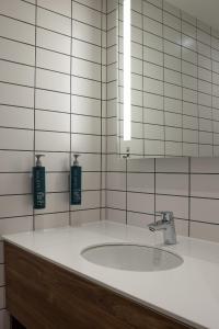 a white bathroom with a sink and a mirror at Hilton Garden Inn Stoke On Trent in Stoke on Trent