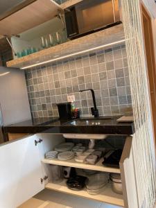 a kitchen with a sink and a counter top at Mana Beach Experience - 62m2 - 2 quartos - 1 Suite - com opcao de terreo tipo studio, 30m2 - Praia de Muro Alto in Porto De Galinhas