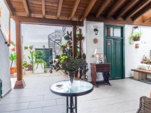 a patio with a table and a green door at Live Arico Casa Abuela in Arico el Nuevo +14 photos