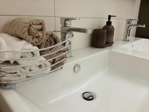 a basket of towels sitting on top of a sink at Cozy apartment in Vienna in Vienna