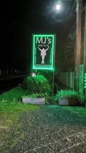 a sign for a mds clinic in the dark at This Is It Airport Hotel and Restaurant in Negombo