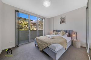 a bedroom with a bed and a large window at Entire apartment in Hornsby in Hornsby