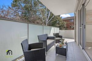 a patio with chairs and a table on a balcony at Entire apartment in Hornsby in Hornsby