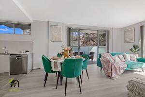 a living room with a table and green chairs at Entire apartment in Hornsby in Hornsby