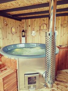 a bath tub in a wooden room with at La Parenthèse Au Bain Nordique in Betton