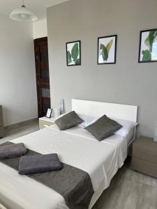 a bedroom with a large white bed with two pillows at F6 Modern and bright Apartment in Malta in Msida