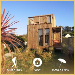 a small wooden house with a person in front of it at Tiny house proche de Morgat in Crozon