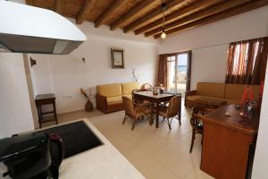 a living room with a table and a couch at Tris Ekklisies Seaside Beach Apartment - Liviko in Paránimfoi