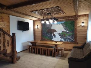 a room with a large painting of a bear on the wall at Dobryi Hutsul 2 in Mykulychyn
