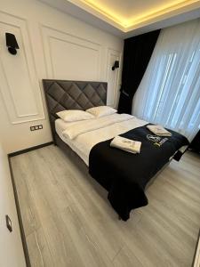 a bedroom with a large bed with a black blanket at X Premium in Kayseri