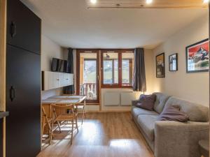 a living room with a couch and a table at Appartement La Mongie, 1 pièce, 4 personnes - FR-1-404-348 in Bagnères-de-Bigorre