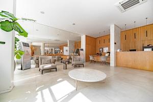 a large living room with a table and chairs at Hotel Plaza Camboriú in Balneário Camboriú