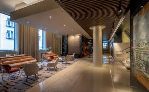 a lobby with couches and chairs in a building at The Morrison Dublin, Curio Collection by Hilton in Dublin