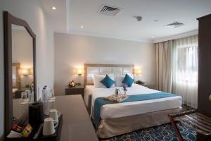Ein Bett oder Betten in einem Zimmer der Unterkunft Carlton Tower Hotel