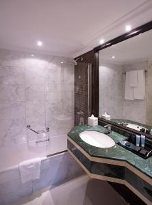 a bathroom with a sink and a shower at Carlton Tower Hotel in Dubai