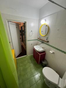 a bathroom with a toilet and a sink and a mirror at Cozy studio stay in Sofia in Sofia