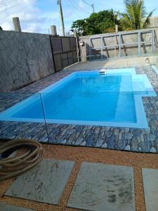 a blue swimming pool with a hose next to it at villas andrez in Savinia
