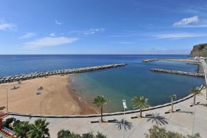 a view of a beach with palm trees and the ocean at Calheta Beach - All-inclusive - Savoy Signature in Calheta