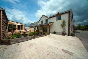 a house with a large driveway in front of it at Oak Barn in Brecon