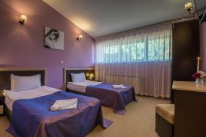 Ένα ή περισσότερα κρεβάτια σε δωμάτιο στο Hotel Royal Borovets