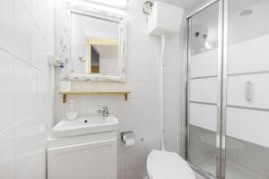 a bathroom with a toilet and a sink and a shower at Pensión Riosol in Seville