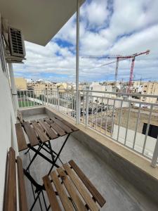 a balcony with a bench and a view of a city at F3-1 Double room with private bathroom and balcony in Msida