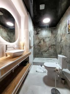 uma casa de banho com um lavatório e um WC em Apartamenty Centrum- Wojska Polskiego em Słupsk