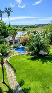 a resort with a swimming pool and palm trees at ARAGUAIA HOTEL in Barra do Garças