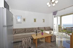 a living room with a couch and a table at Apartment Blue Eyes in Podstrana